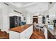 Open kitchen with a large island, stainless steel appliances, and hardwood flooring at 645 S 54Th St, Mesa, AZ 85206