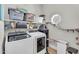 A modern laundry room featuring a front-load washer and dryer, ample shelving, and built in cat climbing features at 645 S 54Th St, Mesa, AZ 85206