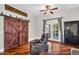 Living room showing wood sliding doors, hardwood floors, ceiling fan, and outdoor access at 645 S 54Th St, Mesa, AZ 85206