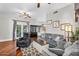 Comfortable living room featuring hardwood floors, ceiling fan, and access to the outdoors at 645 S 54Th St, Mesa, AZ 85206