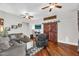 Cozy living room with a fireplace, hardwood floors, and a barn door at 645 S 54Th St, Mesa, AZ 85206