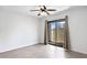 Bedroom featuring wood floors, sliding glass door to patio, neutral paint, and a ceiling fan at 850 S River Dr # 1068, Tempe, AZ 85281