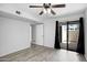 Bedroom with sliding glass door to outdoor patio, neutral paint, and a ceiling fan at 850 S River Dr # 1068, Tempe, AZ 85281