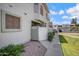 Townhouse exterior with a white fence, desert landscaping, and a sunny sky at 850 S River Dr # 1068, Tempe, AZ 85281