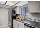 Kitchen featuring stainless steel appliances, granite counters, and a window at 850 S River Dr # 1068, Tempe, AZ 85281