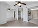 Bright living room featuring light wood floors, mirrored closet, ceiling fan, and an open view of the kitchen at 850 S River Dr # 1068, Tempe, AZ 85281