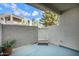 Private patio area enclosed by stucco walls and a white gate with desert landscaping at 850 S River Dr # 1068, Tempe, AZ 85281