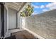 Small outdoor patio surrounded by privacy fence and textured walls at 850 S River Dr # 1068, Tempe, AZ 85281