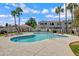 Inviting community pool surrounded by lush palm trees and meticulously maintained landscaping under a bright blue sky at 850 S River Dr # 1068, Tempe, AZ 85281