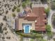 Aerial view of luxury home with pool, red tile roof, and solar panels at 8821 E Havasupai Dr, Scottsdale, AZ 85255