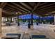 Spacious covered patio with ceiling fans, outdoor seating, and pool access at 8821 E Havasupai Dr, Scottsdale, AZ 85255