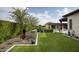 Lush backyard with well-maintained landscaping, artificial grass, and an array of potted plants at 8821 E Havasupai Dr, Scottsdale, AZ 85255
