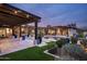 Beautifully landscaped backyard featuring a pool, patio, and string lights at 8821 E Havasupai Dr, Scottsdale, AZ 85255