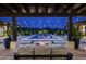 Backyard patio at night with fire pit, pool, and string lights at 8821 E Havasupai Dr, Scottsdale, AZ 85255