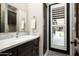 Stylish bathroom featuring a sleek vanity and a door to the exterior at 8821 E Havasupai Dr, Scottsdale, AZ 85255
