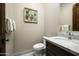 Stylish powder room features a marble countertop, modern fixtures, and decorative wall art at 8821 E Havasupai Dr, Scottsdale, AZ 85255
