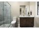 Bright bathroom features a marble-tiled shower and a dark vanity with a marble countertop at 8821 E Havasupai Dr, Scottsdale, AZ 85255