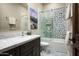 Stylish bathroom featuring a patterned-tile shower-tub combo and marble countertop at 8821 E Havasupai Dr, Scottsdale, AZ 85255