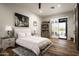 Well-lit bedroom with backyard access features wood floors and a bookshelf at 8821 E Havasupai Dr, Scottsdale, AZ 85255