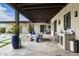Expansive covered patio with an outdoor fireplace and bar, great for hosting guests at 8821 E Havasupai Dr, Scottsdale, AZ 85255