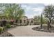 Lovely single-story home with a circular driveway and lush desert landscaping at 8821 E Havasupai Dr, Scottsdale, AZ 85255