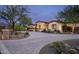 Beautifully landscaped home featuring desert plants and a circular driveway at 8821 E Havasupai Dr, Scottsdale, AZ 85255