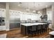 Bright kitchen featuring white cabinets, a large center island, and seating for casual dining at 8821 E Havasupai Dr, Scottsdale, AZ 85255