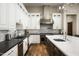 Modern kitchen equipped with stainless steel appliances, marble backsplash, and a stylish range hood at 8821 E Havasupai Dr, Scottsdale, AZ 85255