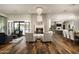 Open concept living room with a fireplace, chandelier, and hardwood floors at 8821 E Havasupai Dr, Scottsdale, AZ 85255