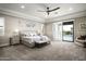 Bright main bedroom with backyard access features neutral tones and sitting area at 8821 E Havasupai Dr, Scottsdale, AZ 85255
