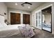 Relaxing main bedroom with access to the outdoor space and two closet doors at 8821 E Havasupai Dr, Scottsdale, AZ 85255