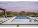 Relaxing pool area with in-pool lounge chairs and a tranquil view of the distant mountains at 8821 E Havasupai Dr, Scottsdale, AZ 85255