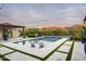 Inviting pool with mountain views, featuring lounge chairs, blue planters, and string lights at 8821 E Havasupai Dr, Scottsdale, AZ 85255