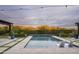 Inviting pool with mountain views, featuring lounge chairs, blue planters, and string lights at 8821 E Havasupai Dr, Scottsdale, AZ 85255