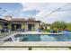 Stunning pool with lounge chairs, landscaping, and string lights, perfect for outdoor relaxation at 8821 E Havasupai Dr, Scottsdale, AZ 85255