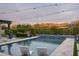 Sparkling pool with mountain views, lounge chairs and string lights at 8821 E Havasupai Dr, Scottsdale, AZ 85255