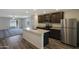 Modern kitchen with granite countertops, stainless steel appliances, and views into the living room at 1102 W West Virginia Ave, Florence, AZ 85132