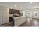 Modern kitchen featuring an island, granite countertops, stainless steel appliances and wood floors at 1102 W West Virginia Ave, Florence, AZ 85132