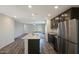 Stylish kitchen with stainless steel appliances, granite countertops, open to the living area, and wood floors at 1102 W West Virginia Ave, Florence, AZ 85132