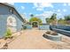 Spacious brick-paved backyard with a built-in fire pit, garden, and access to the upper deck via spiral staircase at 12501 E Cloud Rd, Chandler, AZ 85249