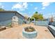 Expansive brick-paved backyard with a built-in fire pit, garden, and upper deck access via spiral staircase at 12501 E Cloud Rd, Chandler, AZ 85249