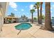 Backyard oasis featuring a sparkling pool, mature palm trees, and a spacious concrete patio at 12501 E Cloud Rd, Chandler, AZ 85249
