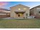 A sprawling backyard with lush green grass, a patio area, and an outdoor kitchen perfect for entertaining at 13553 N 141St Ln, Surprise, AZ 85379