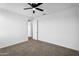 This bedroom has neutral paint, carpet and a ceiling fan and adjoins a closet at 13553 N 141St Ln, Surprise, AZ 85379