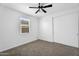 Bedroom with sliding closet doors, neutral walls, carpet flooring, and a ceiling fan at 13553 N 141St Ln, Surprise, AZ 85379