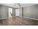 Bedroom with wood-look floors, neutral walls, and an open doorway to a closet at 13553 N 141St Ln, Surprise, AZ 85379