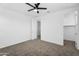 This bedroom has neutral paint, carpet and a ceiling fan and adjoins a closet at 13553 N 141St Ln, Surprise, AZ 85379