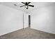 Bedroom with carpet, a fan, neutral walls, and an open door at 13553 N 141St Ln, Surprise, AZ 85379