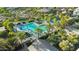 Aerial shot of community pool surrounded by lush landscaping, perfect for Gathering fun and relaxation at 13553 N 141St Ln, Surprise, AZ 85379