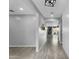 Bright entryway featuring wood-look tile flooring, light gray walls, shiplap accent wall, and modern lighting at 13553 N 141St Ln, Surprise, AZ 85379